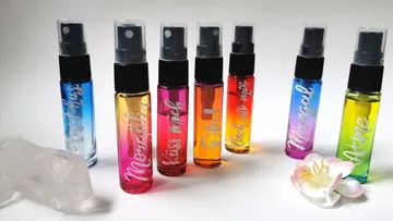 Colorful perfume bottles on white background.