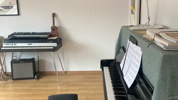 Piano and synthesizer in music room.