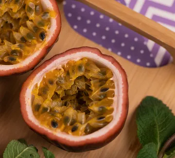 Sliced passion fruit on wooden board.