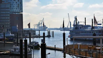 Boats docked at a busy harbor waterfront.