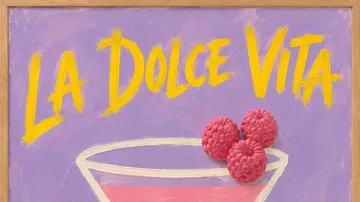 Cocktailglas mit Himbeeren auf lila Hintergrund.