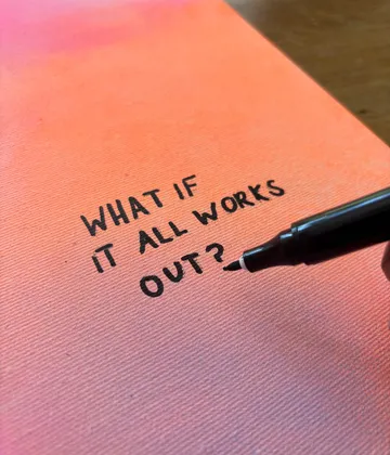 Marker writing on orange notebook cover.