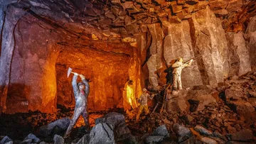 Statues mining inside a rocky cave.