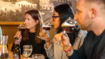 People tasting beer in a cozy bar.