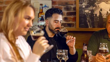 People tasting beer in a cozy bar.