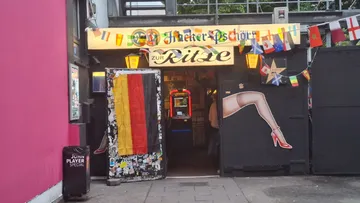 Bar entrance with flags and a disco ball.