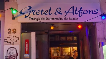 Bar entrance with colorful lights outside.