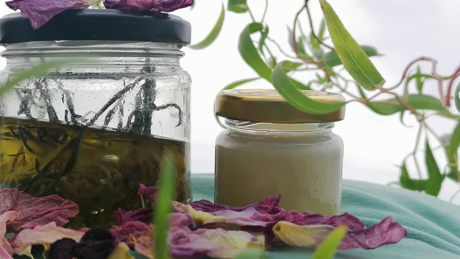 Glass jars with plants and petals nearby.