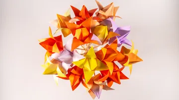 Colorful origami stars arranged in a sphere.
