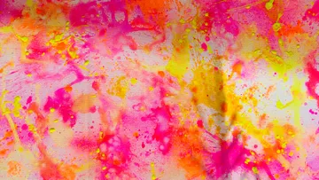 Colorful splatter paint on canvas, abstract design.