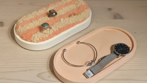 Jewelry and watch on wooden table.