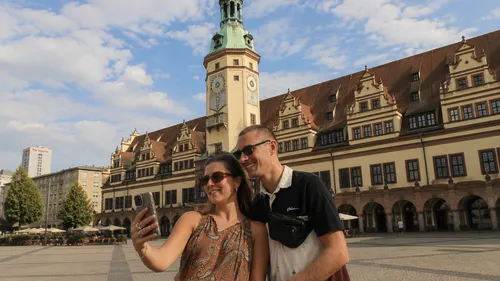 Couple taking selfie in historic square.