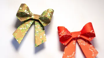 Two origami bows on a white surface.