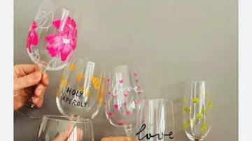 Colorful wine glasses being clinked together.