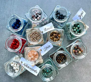 Glass jars filled with colorful beads.