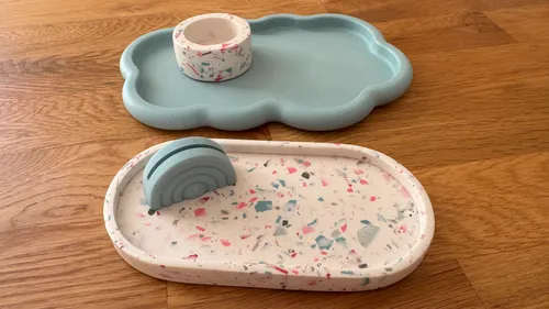 Two decorative trays on wooden surface.
