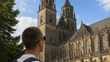 Person looking at a large cathedral exterior.