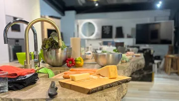 Kitchen counter with vegetables and cheese.