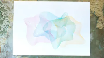Abstract lines forming colorful wave pattern on paper.
