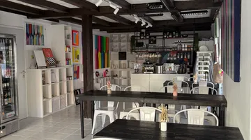 Café-Innenraum mit bunten Gemälden.