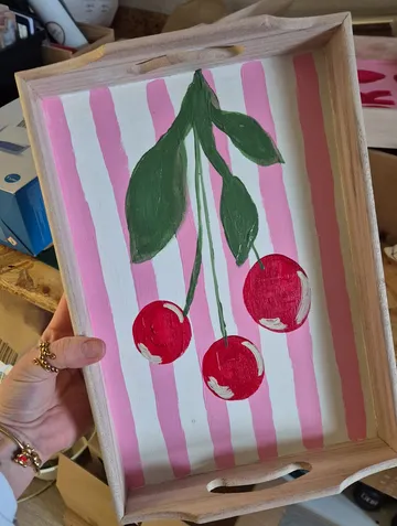 Wooden tray with painted cherries and stripes.