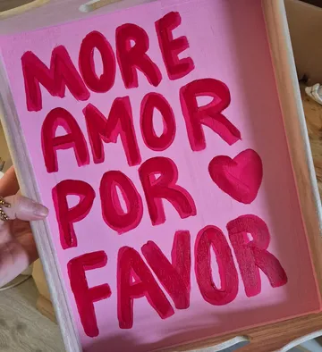Wooden tray with painted message displayed.