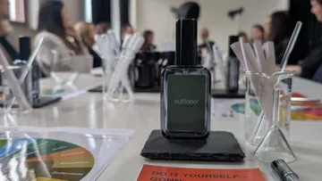 Perfume bottle on table in workshop setting.