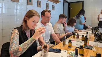 People crafting perfumes at a workshop table.