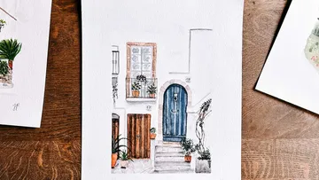 Aquarellmalerei einer charmanten Hausfassade.