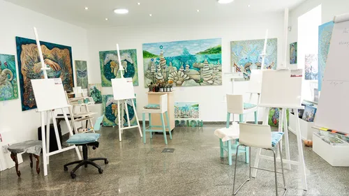 Art studio with easels and paintings.