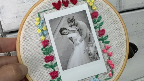 Photograph of couple on embroidered frame.