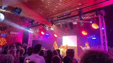 People on stage performing, audience watching.