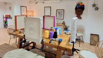 Craft studio with yarn and art supplies.