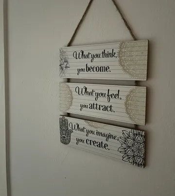 Decorative sign with inspirational quotes on wall.