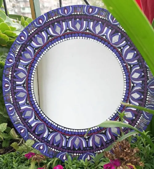 Decorative mirror in garden setting.