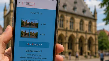 Smartphone displaying quiz app in city setting.
