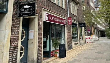 Street with storefronts in urban setting.