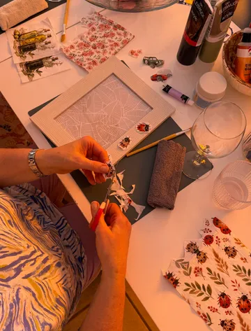 Person cutting ladybug prints for craft project.