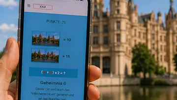 Phone displaying puzzle, castle in background.