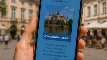 Hand holds smartphone showing Schwerin Castle.