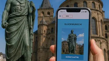 Smartphone showing statue photo beside real statue.