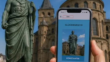 Phone displays statue near historical building.