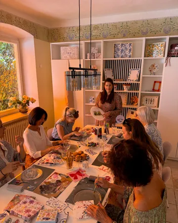 Group doing crafts at a table indoors.