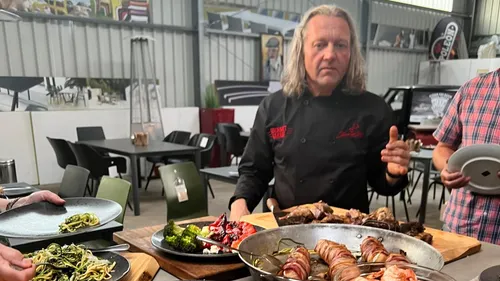 Chef presenting dishes in a restaurant.