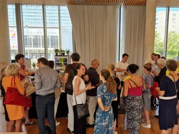 Many people gather in one room to network.