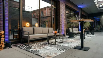 Outdoor patio with sofas and tables.