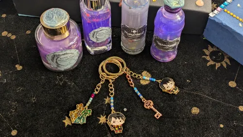 Keychain charms on mystical-themed table.