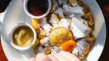 A plate of Kaiserschmarrn with sauces, garnished with fruit.