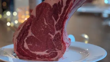 Rohes Steak steht auf einem Teller drinnen.