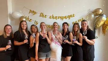 Women holding glasses at a celebration.